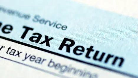 A sharp, close-up shot of the top of a federal income tax return form, focusing on the words "Tax Return."