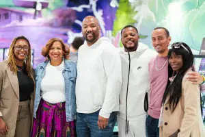 Group of smiling people at Nuna Harvest cannabis dispensary event