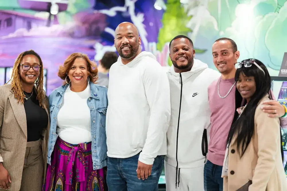 Group of smiling people at Nuna Harvest cannabis dispensary event