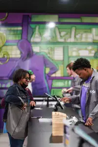 Customer making a purchase at Nuna Harvest dispensary checkout