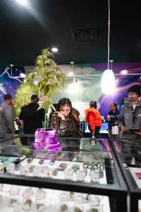 customer admires cannabis products- Nuna Harvest