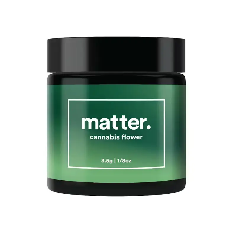 A large, dark green ceramic jar with a black lid and white text that says "matter." on the front, set against a plain white background.
